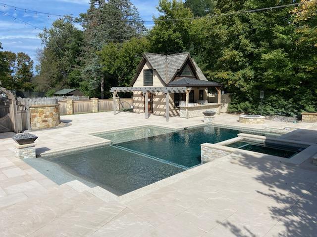 Stunning inground pool with paver, brickwork, and coping completed by Pace Landscaping in Buffalo, NY.